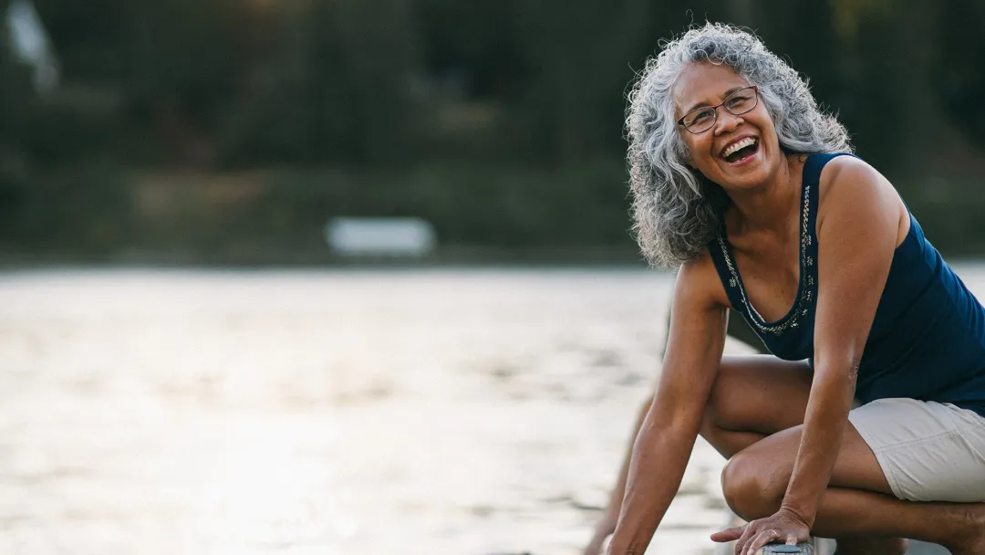 Woman grabbing boat from lake.