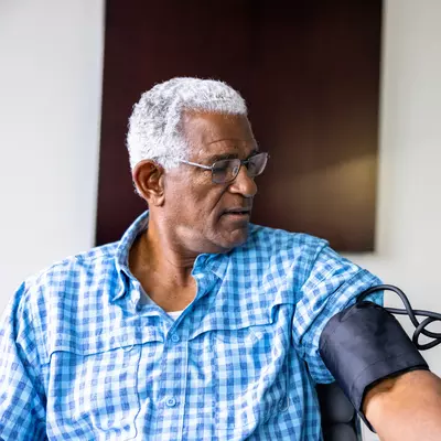 A Patient Has His Blood Pressure Taken By a Nurse in a Practice.