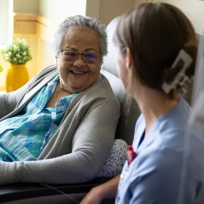 Nurse with senior woman patient in emergency room.