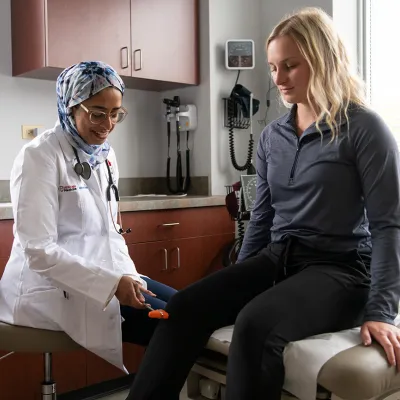 Doctor with patient checking knee functionality