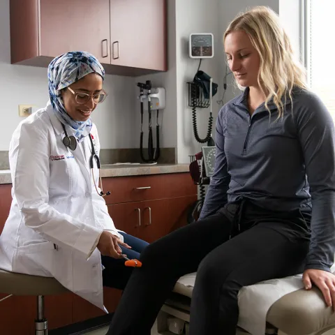 Doctor with patient checking knee functionality