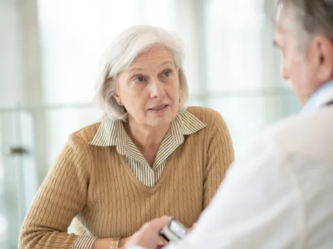senior woman speaking with doctor