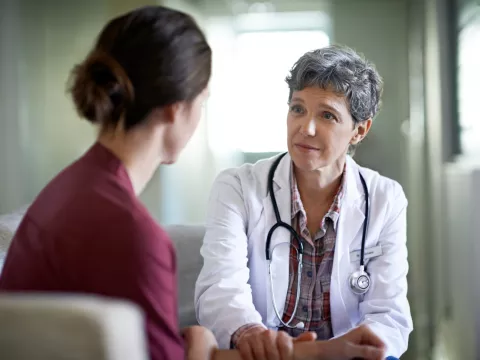 A Physician Comforts A Young Woman