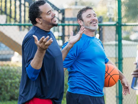 Group of men staying healthy playing basketball