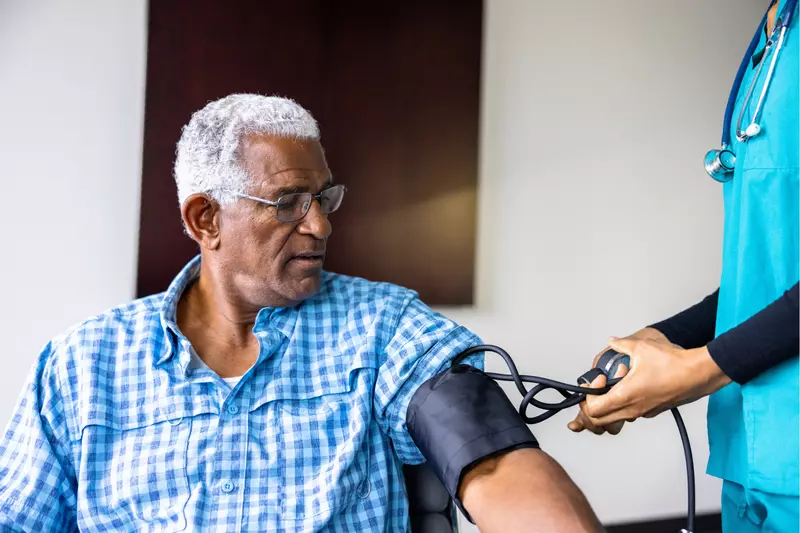 A Patient Has His Blood Pressure Taken By a Nurse in a Practice.