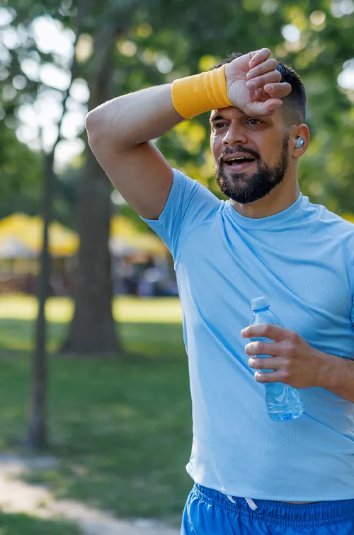 Man Wiping Forehead with Sweatband